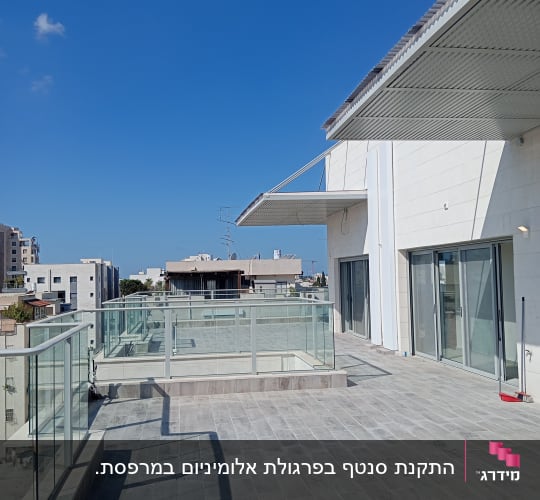 מרפסת עם רצפת אריחים ומעקה זכוכית